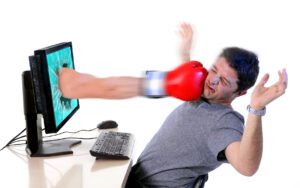 man with computer hit by boxing glove social media cybermobbing and cyberbullying ,  mobbing and bullying concept isolated on white background