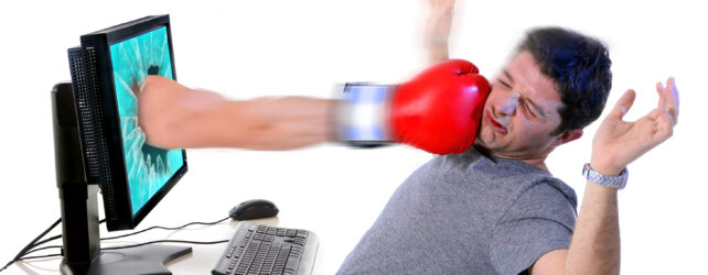 man with computer hit by boxing glove social media cybermobbing